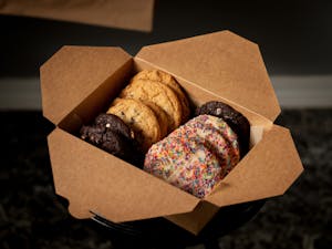 a variety box of cookies including chocolate cookies and rainbow sprinkle cookies