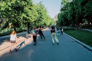 A group rollerskating down a scenic road together