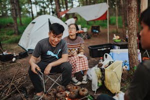 an asian man and woman camping