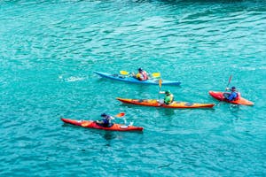 a group of people on kayaks is bright crystal blue, clear waters