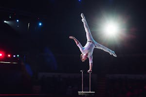 Man's aerial acrobatics in the Circus - one-handed handstand