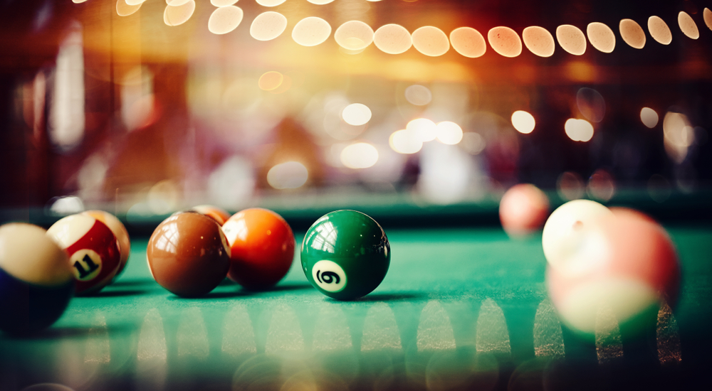 Colorful billiard balls on a green billiard table. Gambling game of Billiards. Billiard ball with number nine.