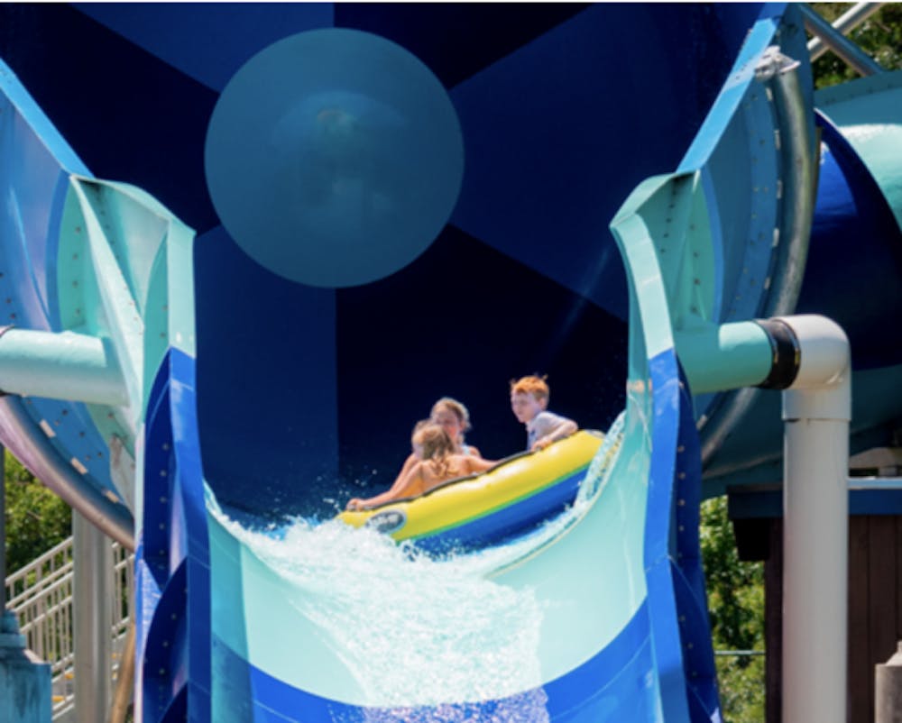 a family going down a waterslide in a tube