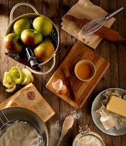 the ingredients to bake an apple pie on the counter