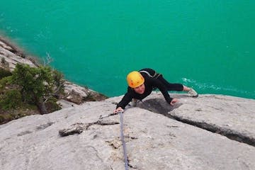 Woman rock climbing a limestone wall in Jasper