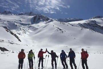 A group of skiers on a snow covered mountain during their Robson Valley AST1 course