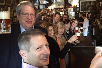 A tour group having beer at a bar
