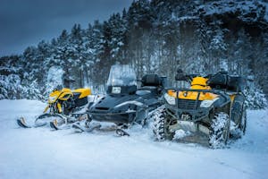 Winter Motorcycle. Snowmobile. Winter ATVs. Winter ATVs in winter against the backdrop of the mountain.