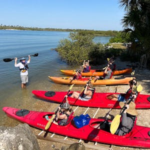 a Ripple Effect Ecotours instructor showing paddle instruction with guests in kayaks