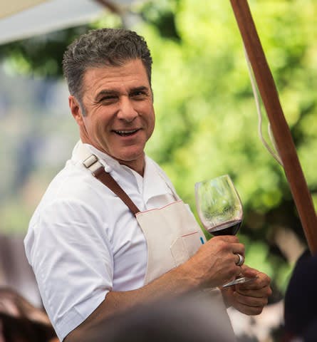 Michael Chiarello holding a glass of wine