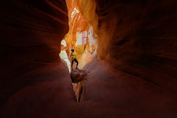 A guest is seen canyoneering through the chambers of Elkheart Canyon and captures a photo-worthy moment
