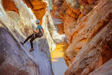 a woman canyoneering in zion