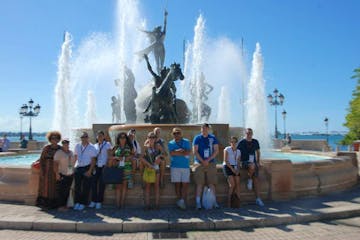 A tour group in front of a large fountain in San Juan