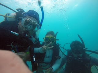 Three scuba divers taking a selfie