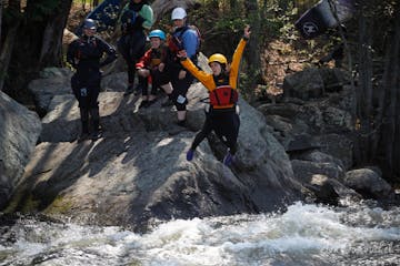 person jumping into whitewater