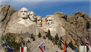 Mount Rushmore with flags