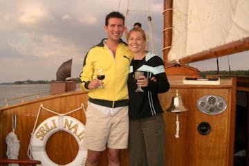 two people toasting on the sailboat