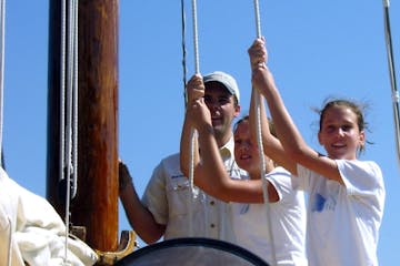tugging on ropes on the sailboat