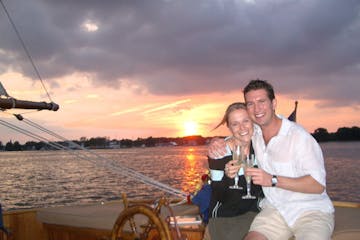 couple toasting at sunset with champagne