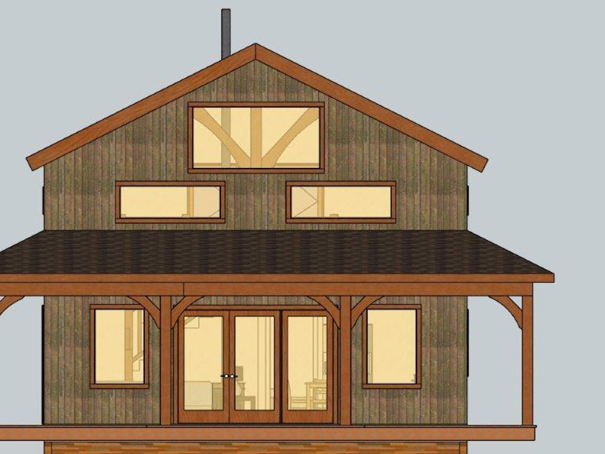 Front façade of Nowhere cabin. The cabin has a huge porch on the lower floor. The lower floor has two huge windows and a huge door that is also windows. The upper floor has three large windows and you can see the cabin beam structure inside.