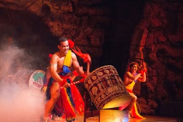 A man banging on Tonga drums
