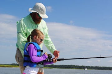 man showing child how to fish