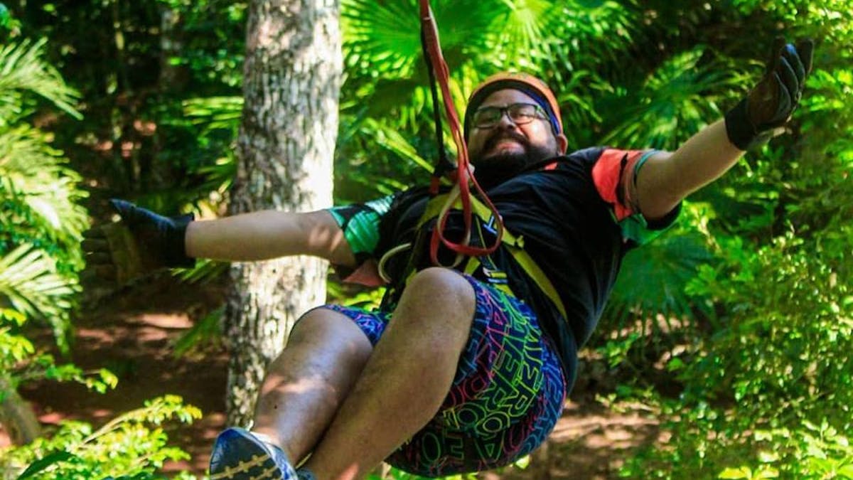 Man ziplining through jungle in Cancun