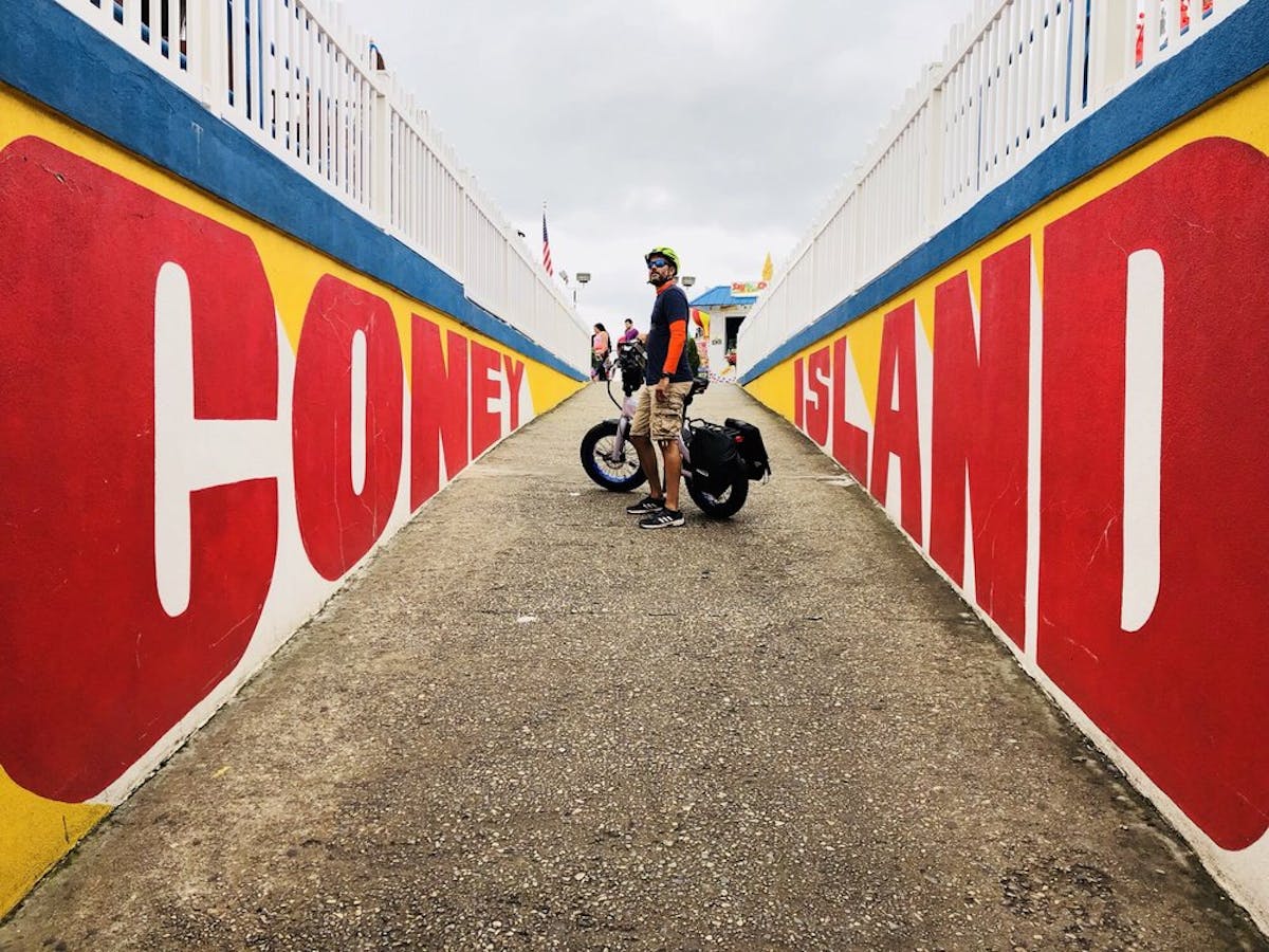 ebike rider with coney island sign