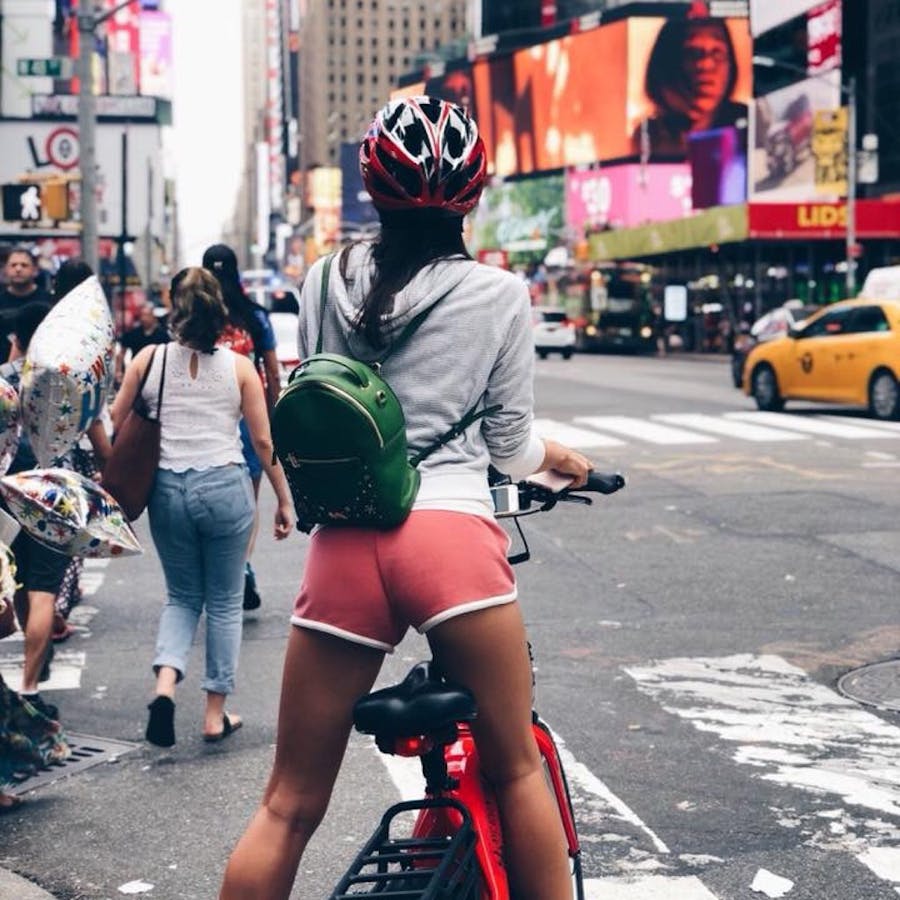 behind view of girl riding ebike in nyc