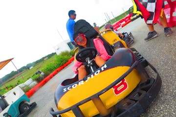 A woman having a fun time driving her go-kart