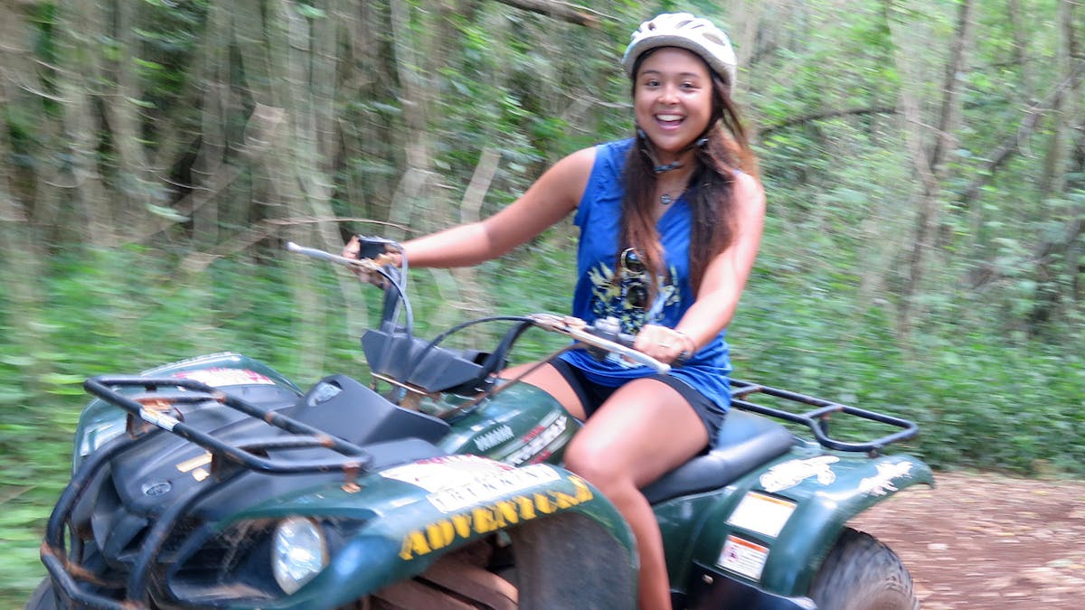 A young woman driving her ATV