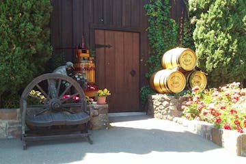 Barrels of wine in front wooden door