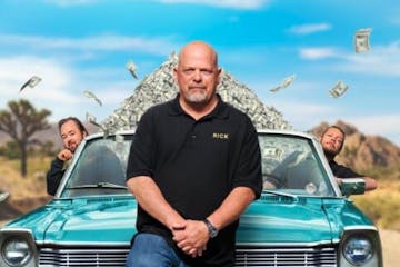 Rick Harrison standing in front of a car posing for the camera