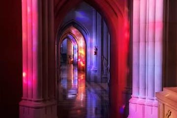Purple and red light over the arches of the National Cathedral