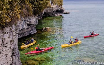 Kayakers paddling toward Cave Point in Wisconsin