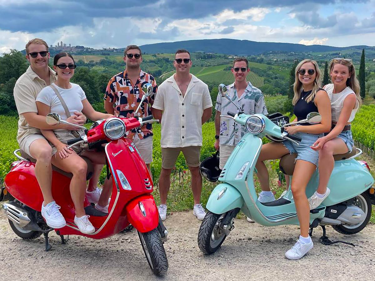 a group of people sitting on a motorcycle