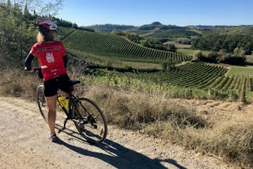 Bike rider in a tuscan field in Francigena trail
