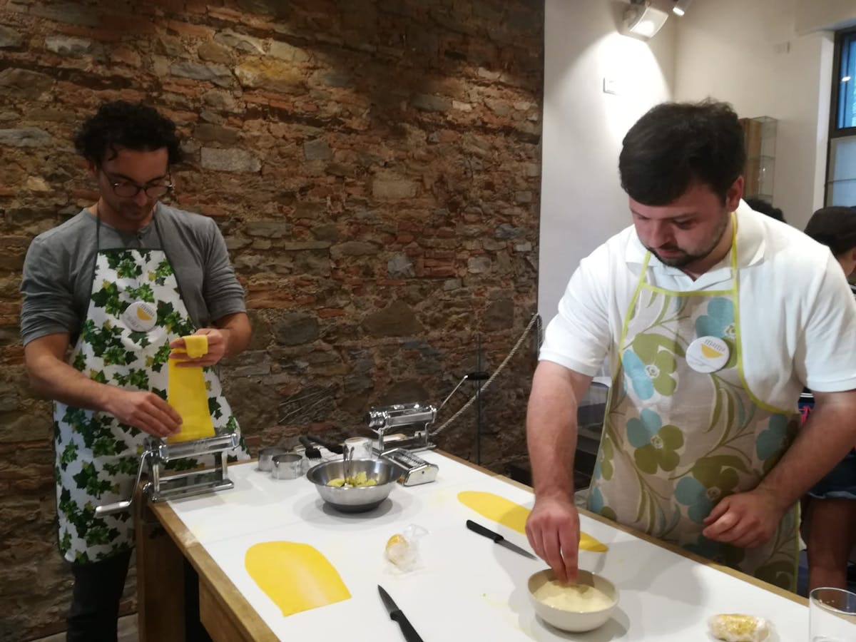 two men making pasta