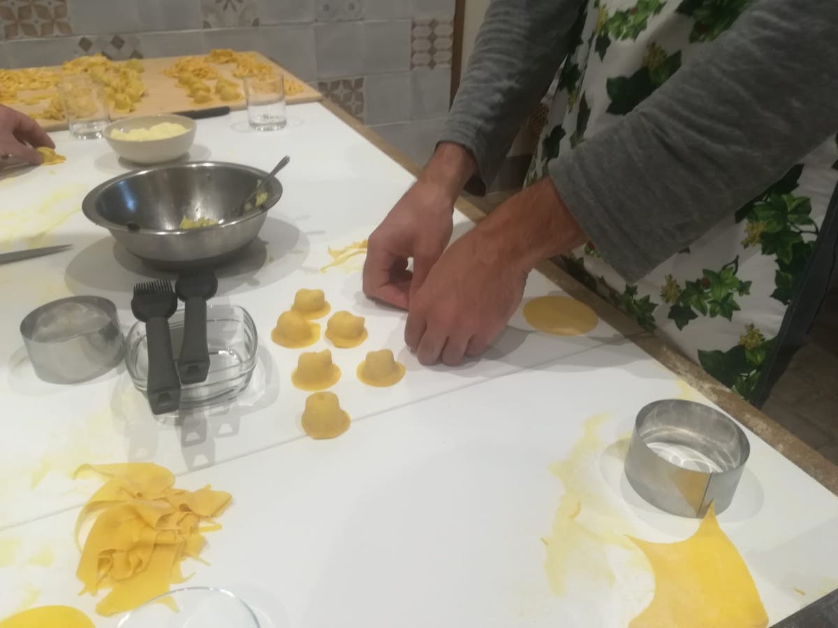 a person making pasta in Tuscany