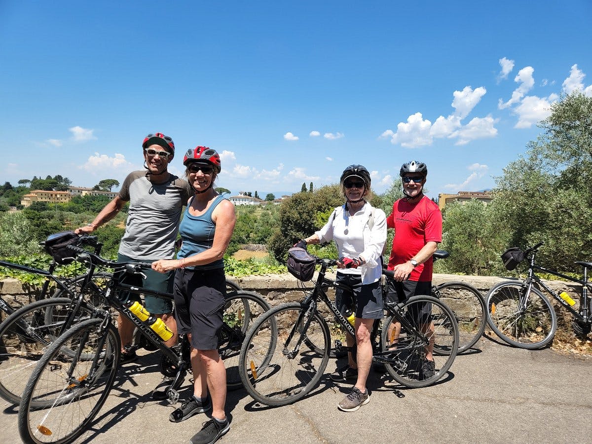 a group of people standing next to a bicycle