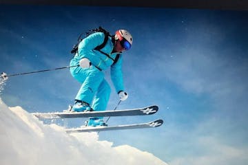 a man flying through the air while riding skis