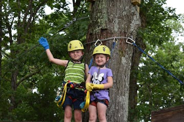 2 young children enjoying the Soaring Six kid-friendly zipline
