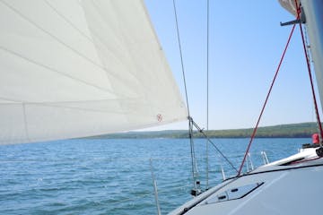 Looking out from bow of sailboat to lake