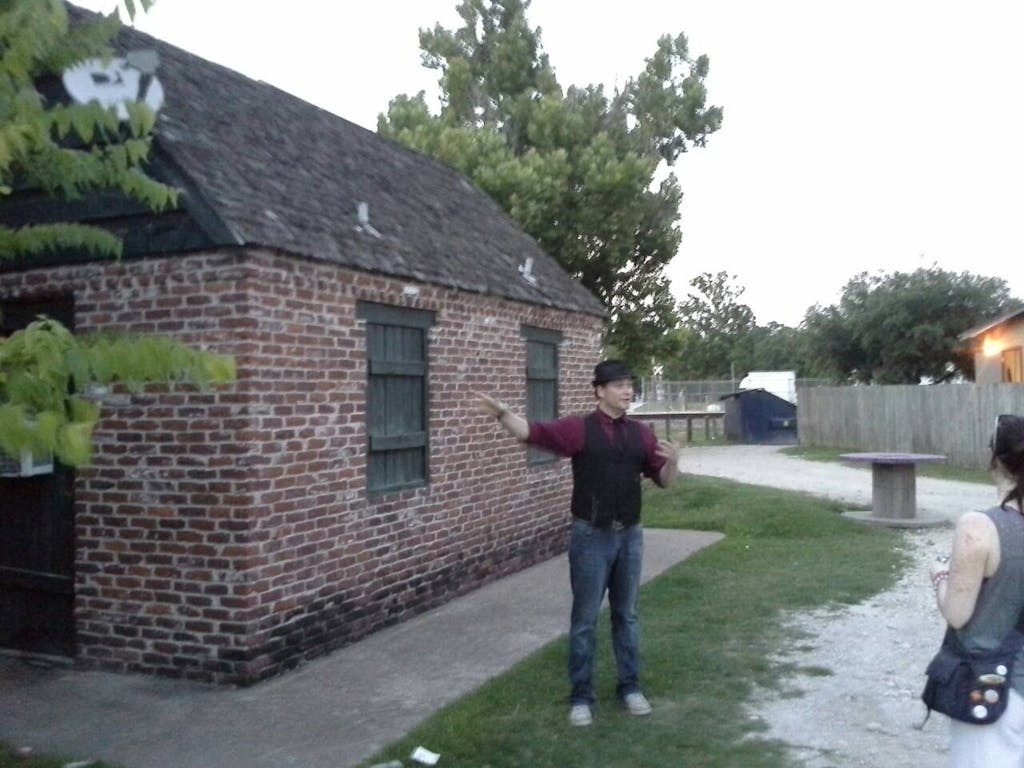 a man standing in front of a brick building