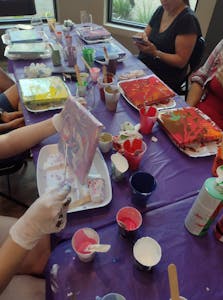 a group of people sitting at a table eating food