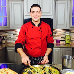 Fabio Carella cooking in a kitchen preparing food