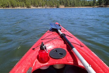 Tip of red kayak looking out to lake and shoreline