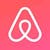 White Airbnb logo, a triangle shape on a pink background