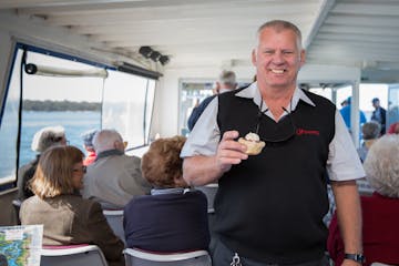 Ferryman Cruises Bribie man with scone