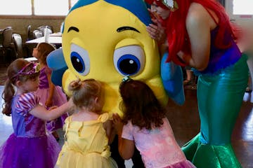 flounder and little mermaid with little girls dressed as princesses